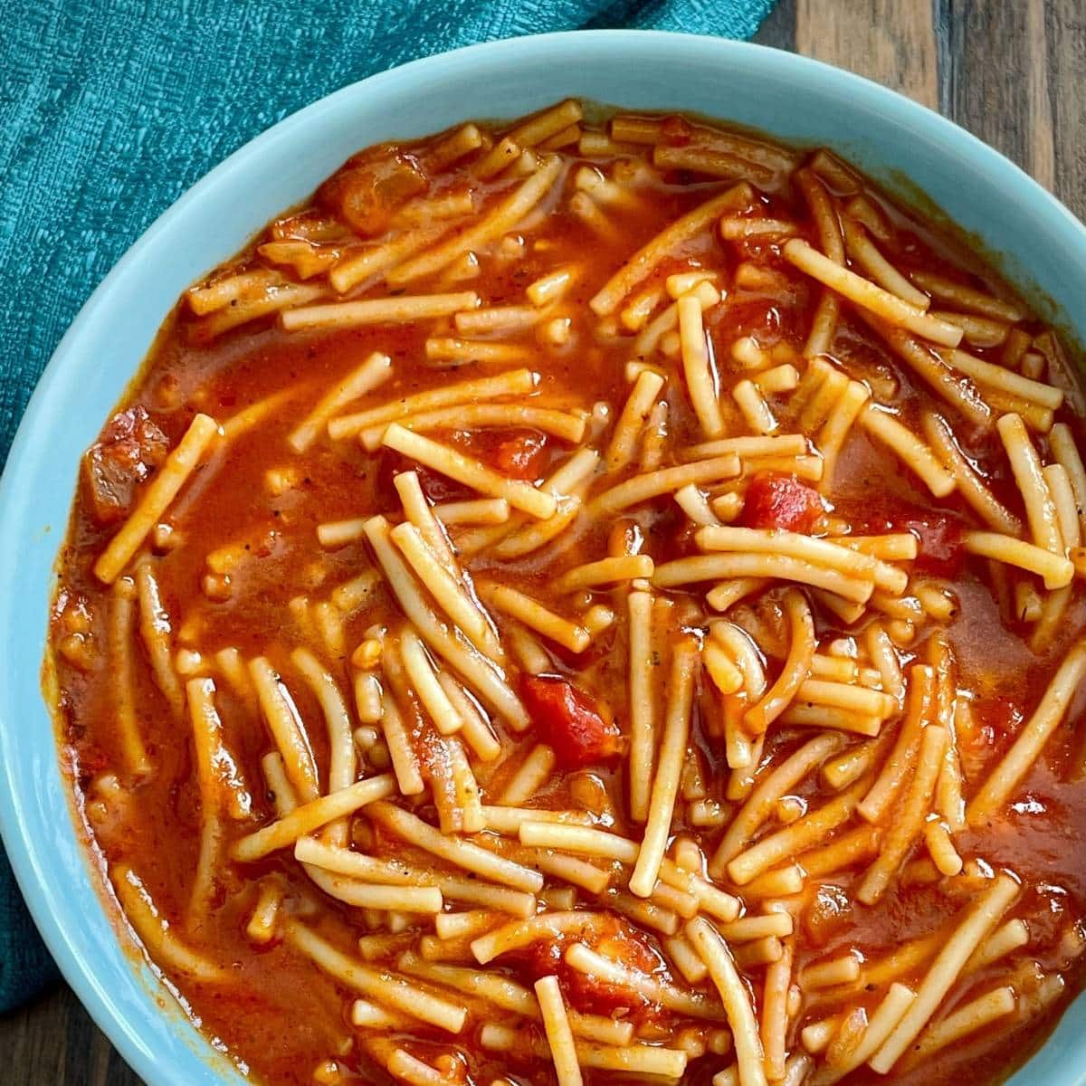 Blue bowl with vegan Mexican noodle soup.