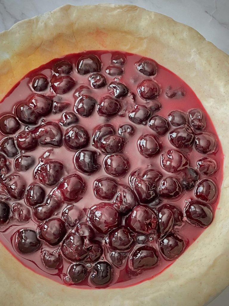 Cherry pie filling in a pie plate.