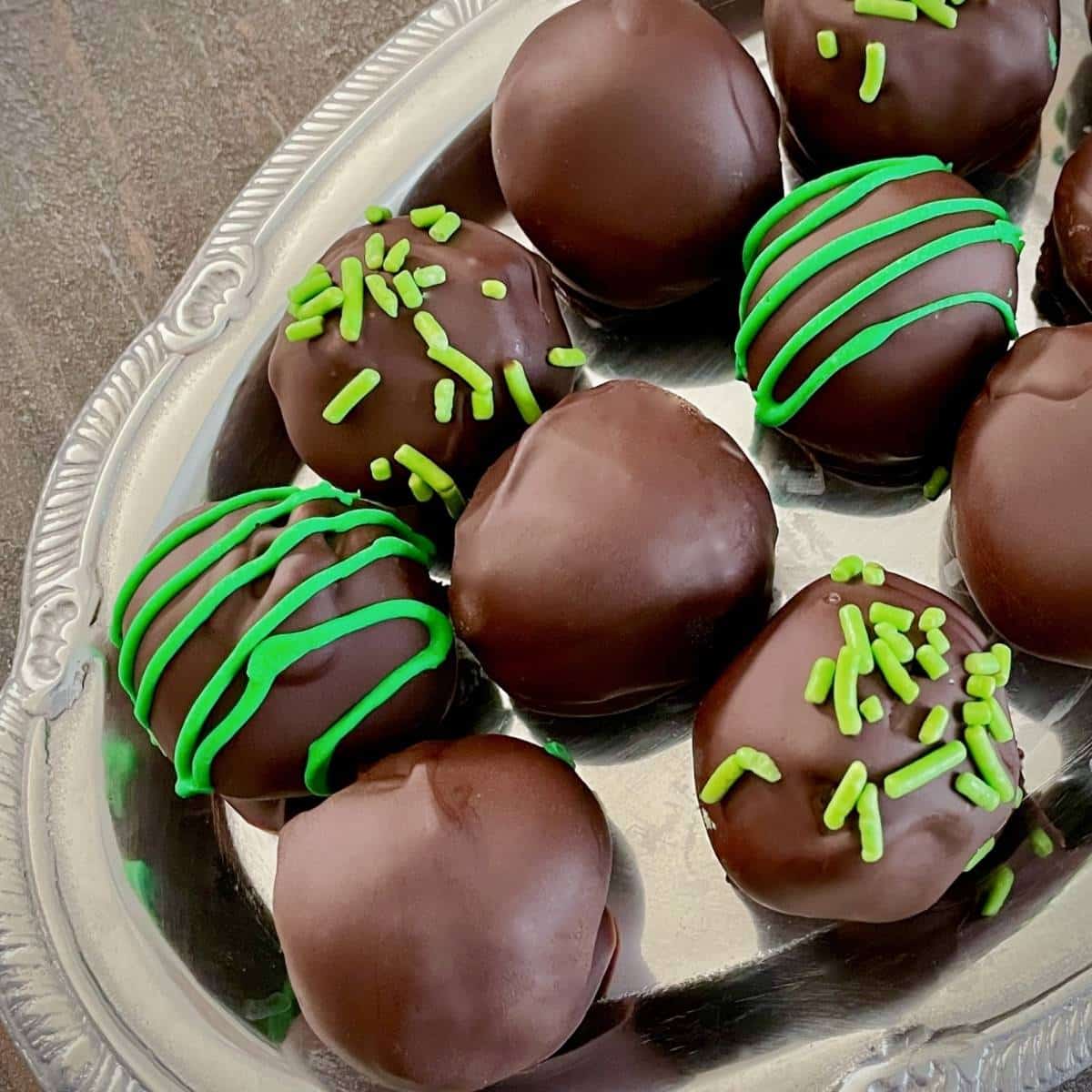 A tray with vegan chocolate mint truffles and green icing.