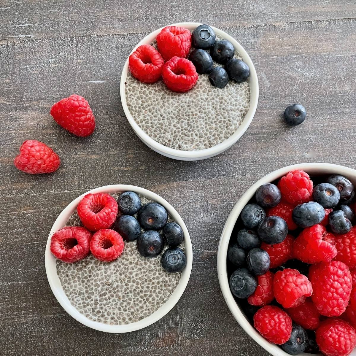Two bowls of chia pudding with fresh fruit.