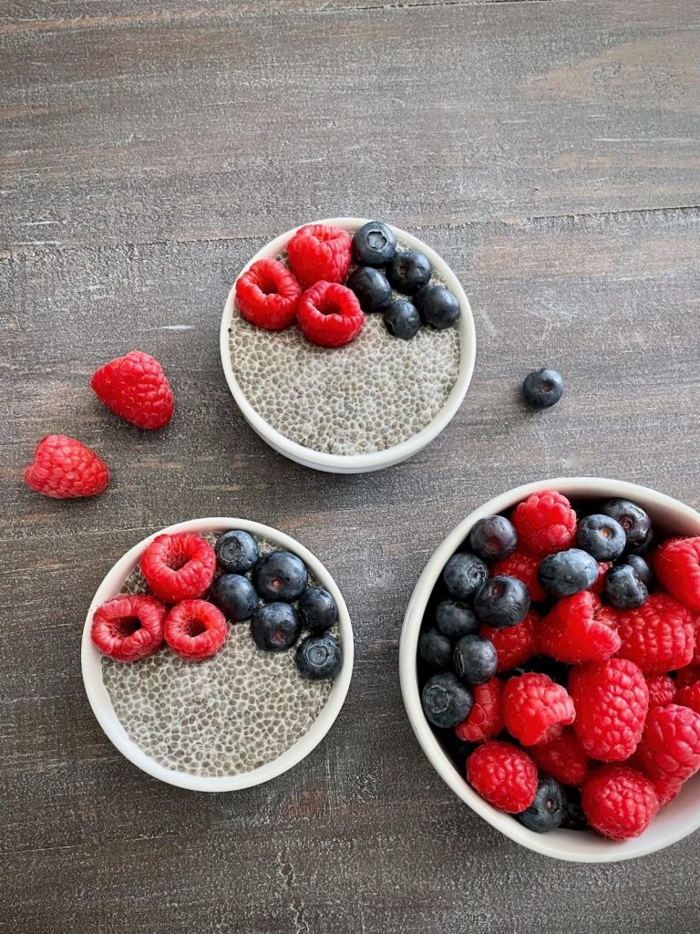Two bowls of chia pudding with fresh fruit.