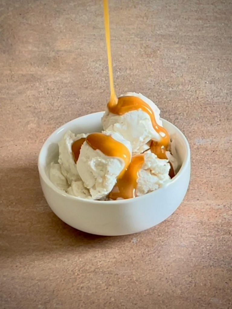 Butterscotch sauce drizzled over ice cream.