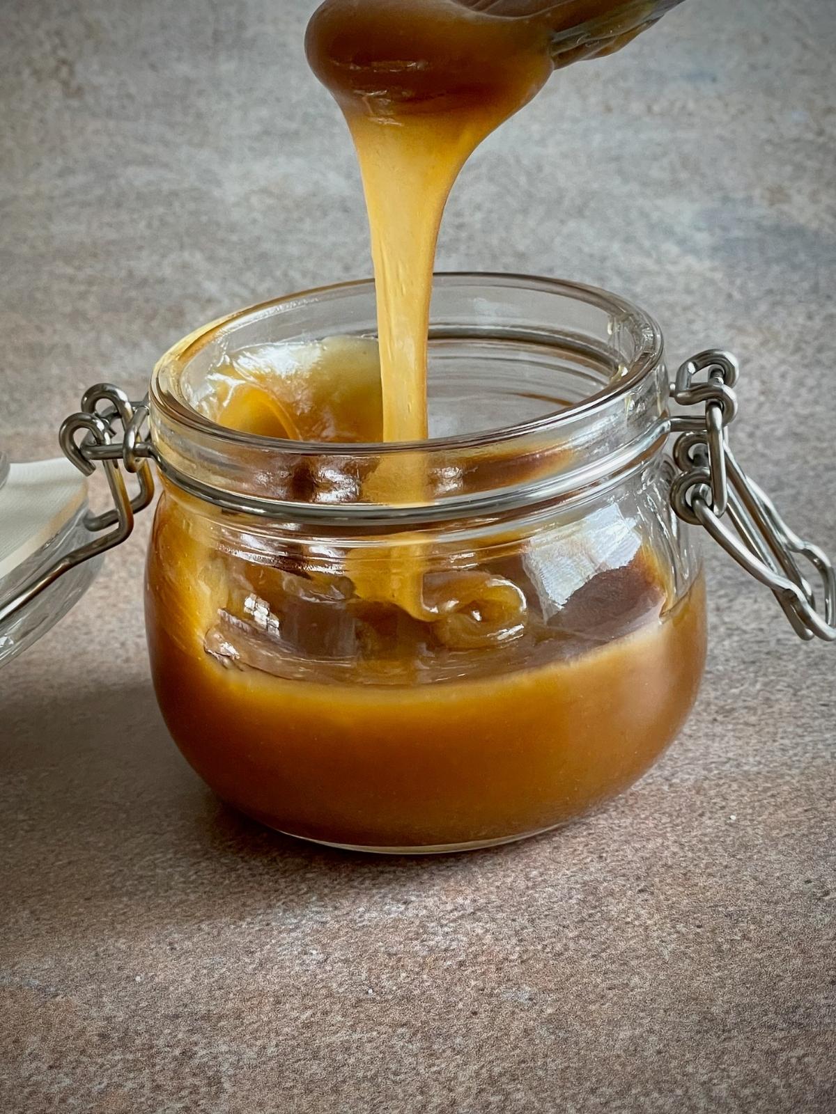 Pouring sauce into a jar.