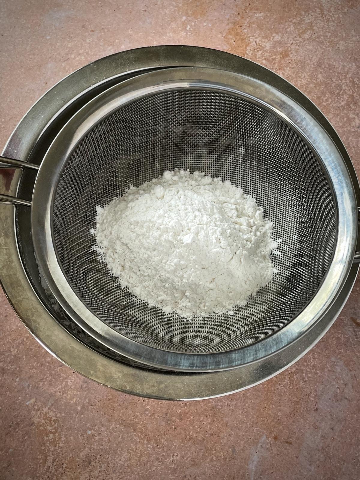 Sifting powdered sugar.