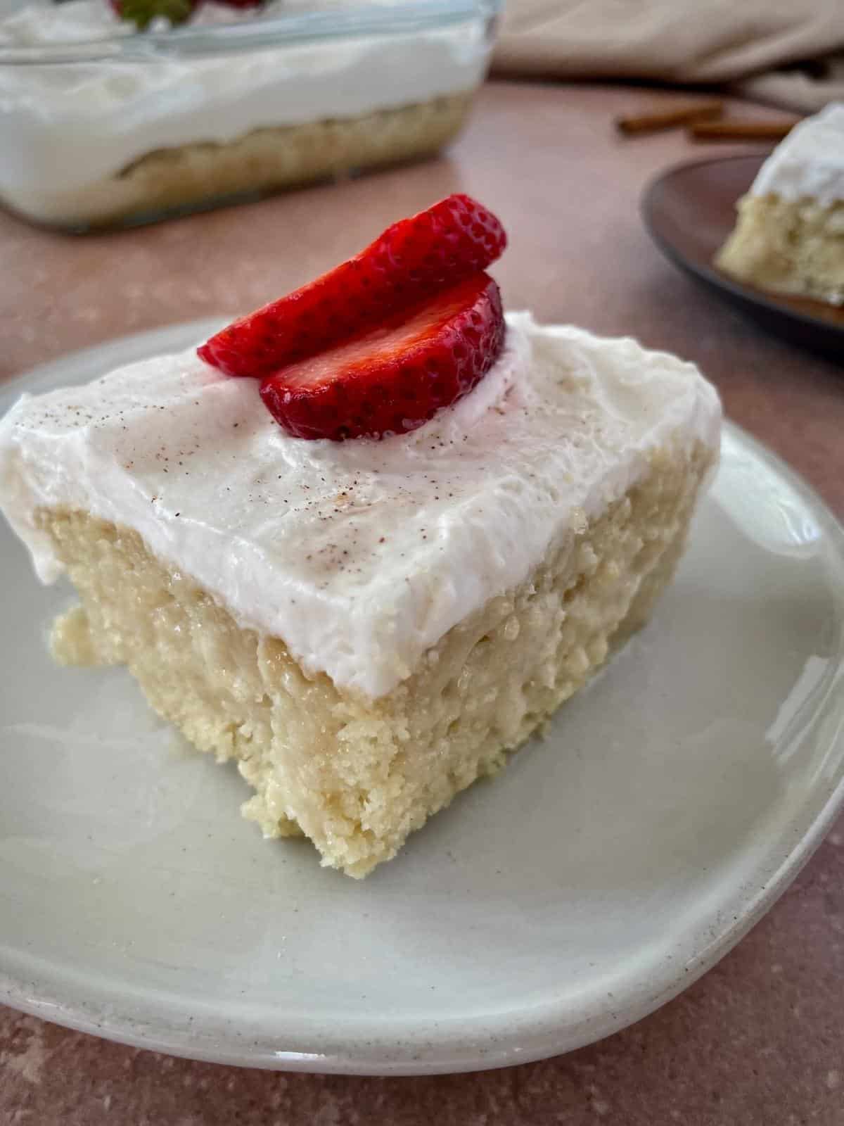 Tres leches slice of cake with strawberries.