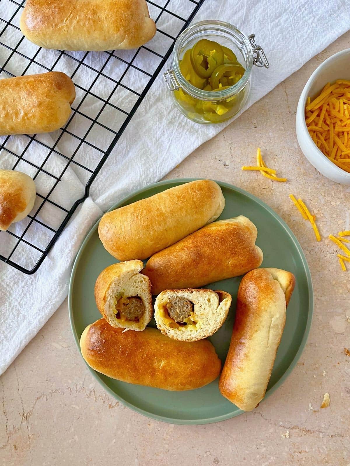 Sausage and cheese kolaches on a plate.