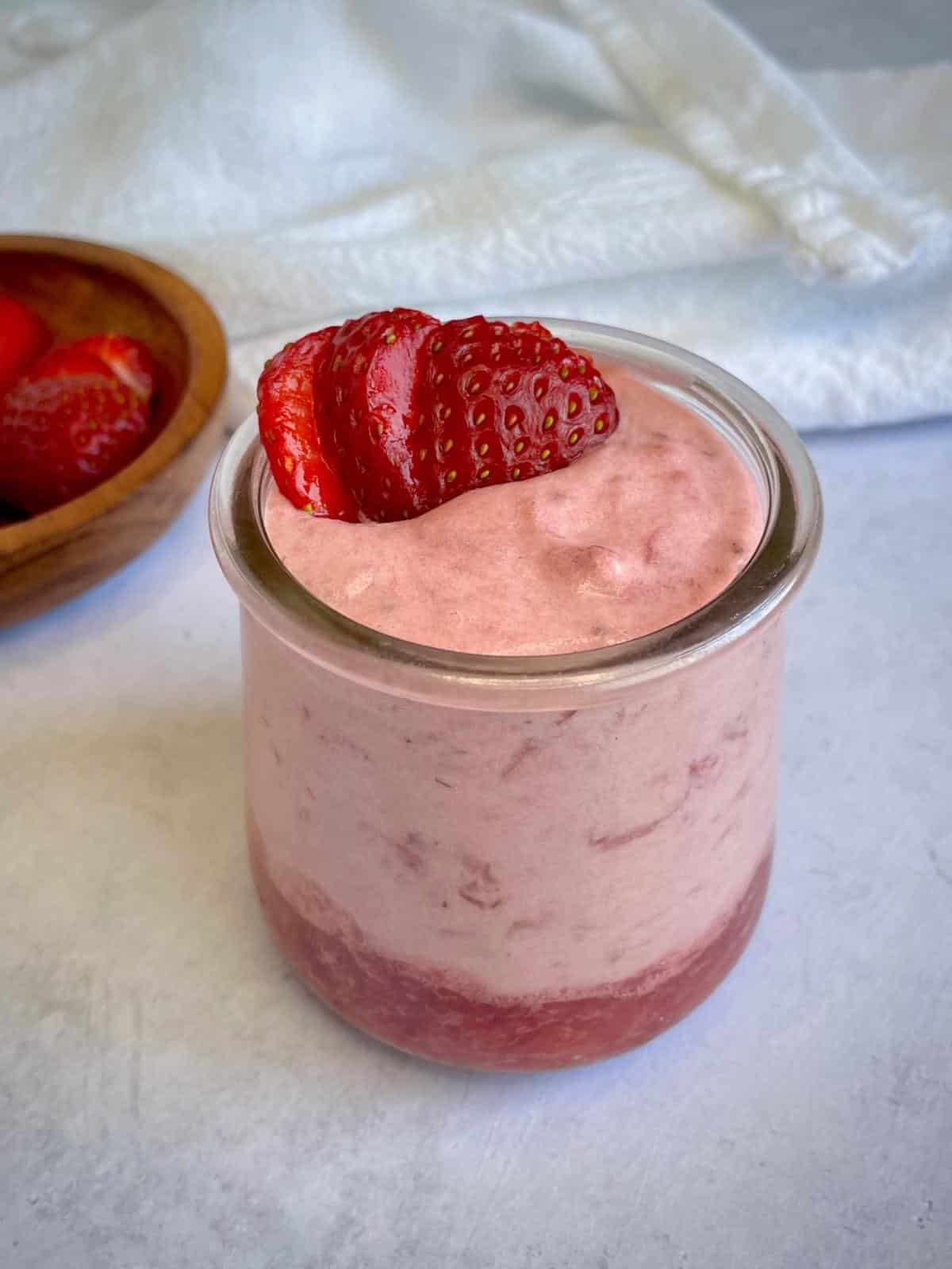 Vegan strawberry mousse in a jar.