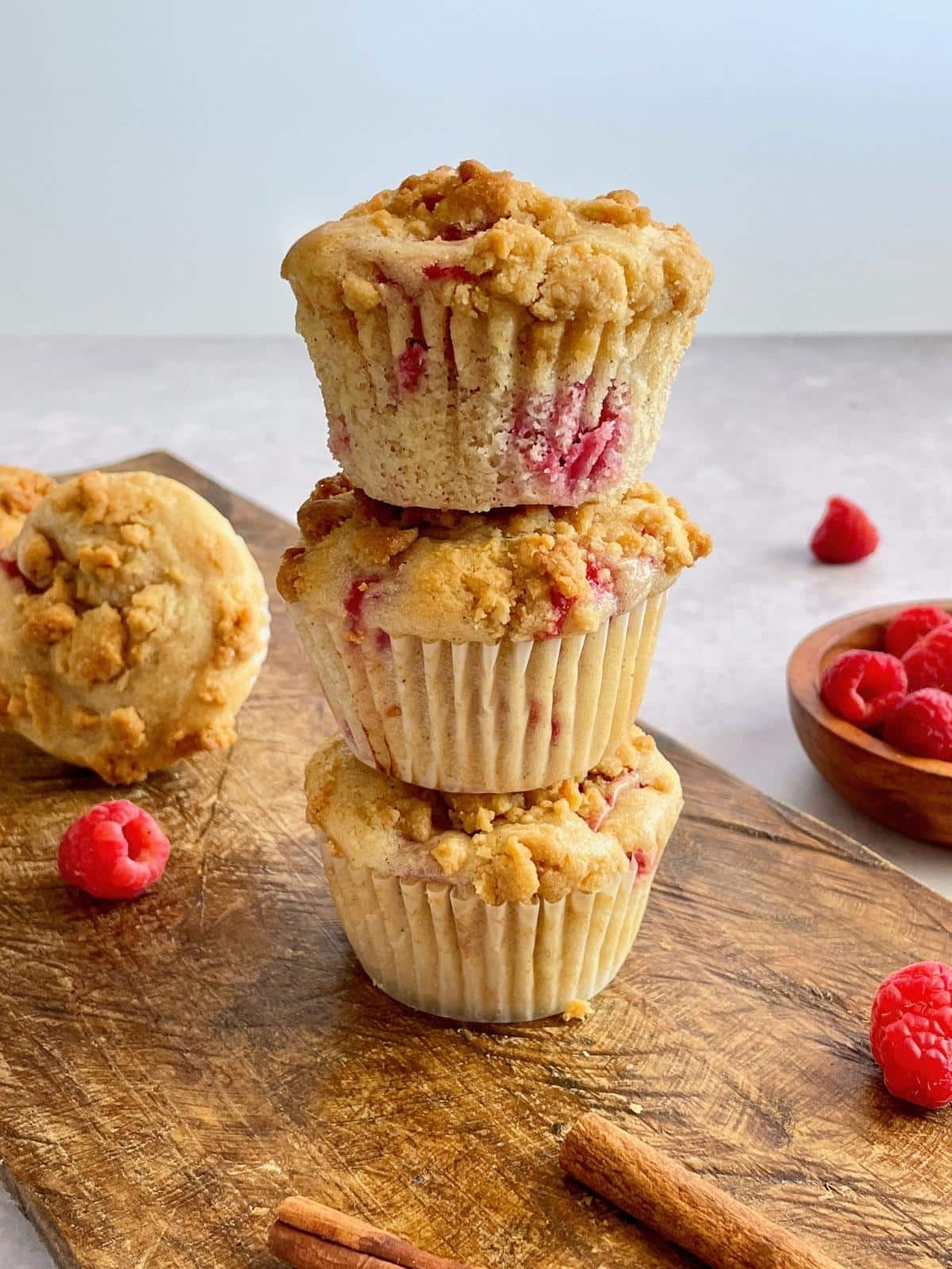 Vegan raspberry muffins stacked on each other.