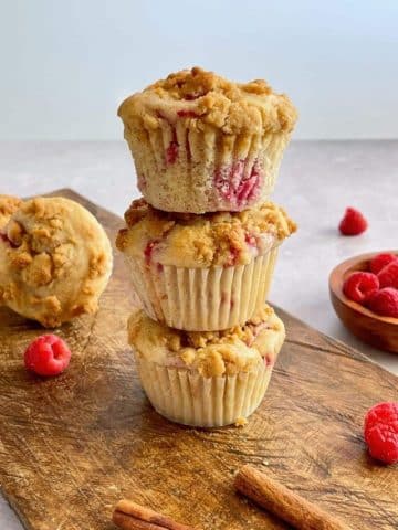 Vegan raspberry muffins stacked on each other.
