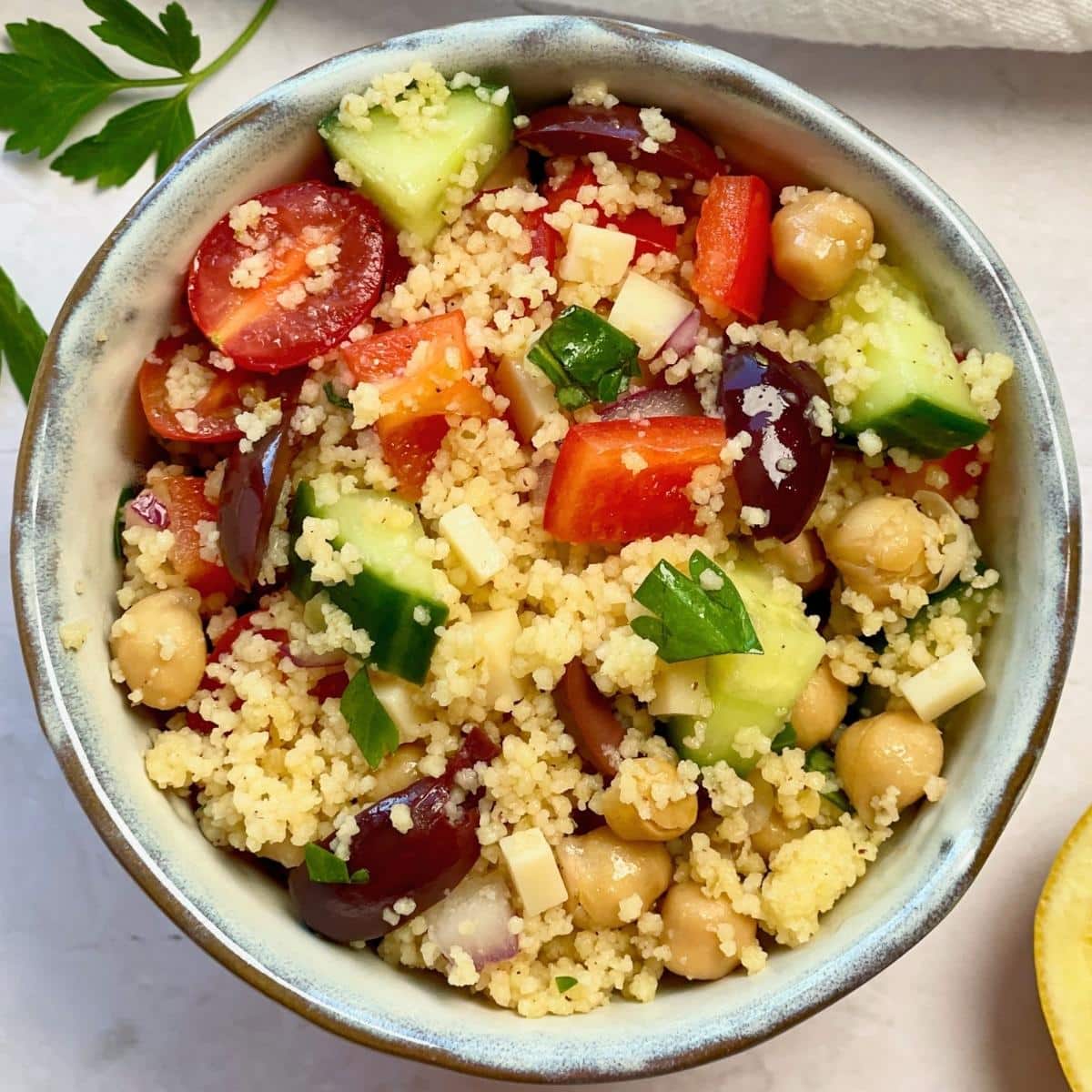 Bowl of vegan Mediterranean couscous salad.