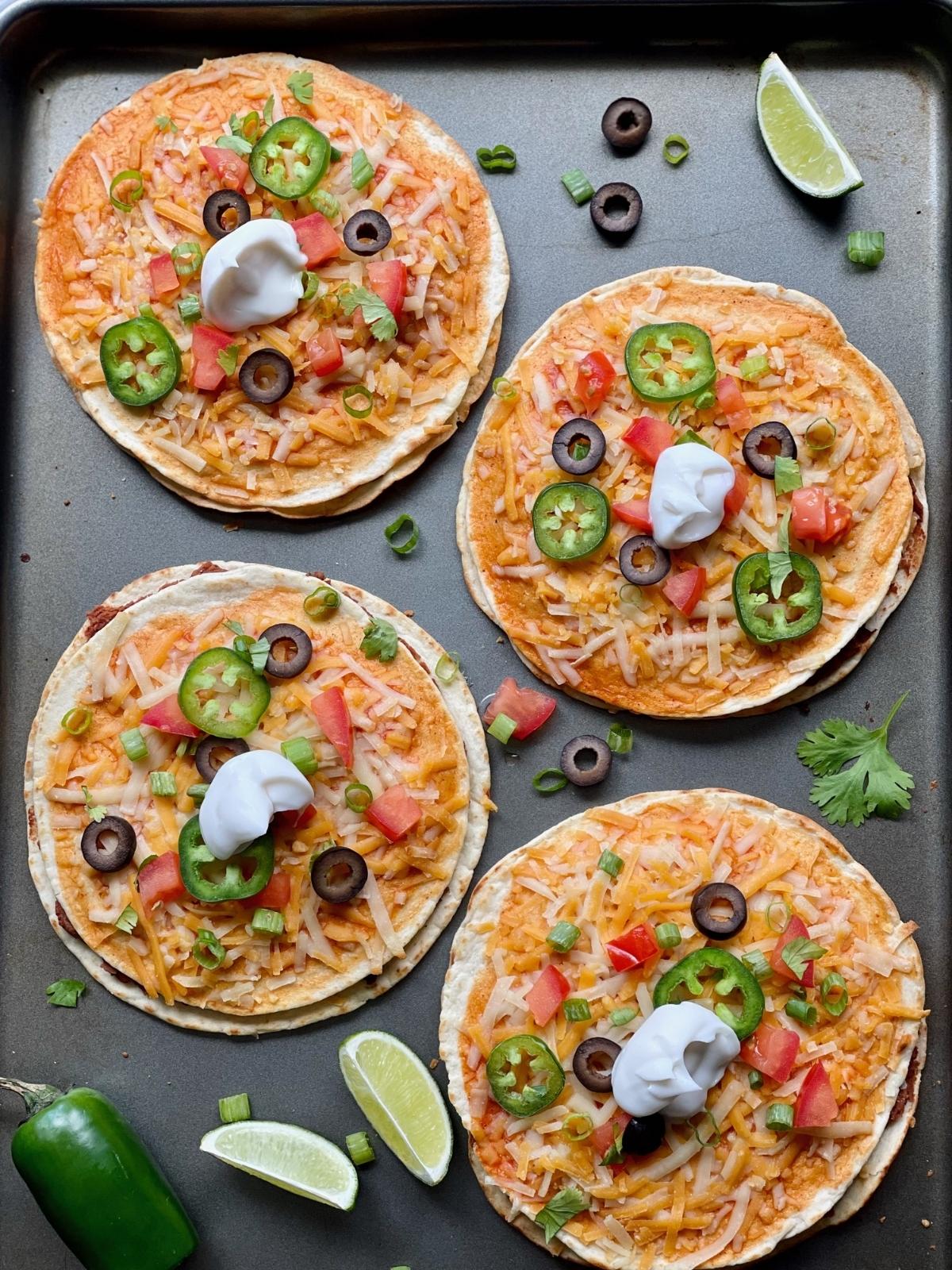 Vegan Mexican pizzas on a sheet pan.