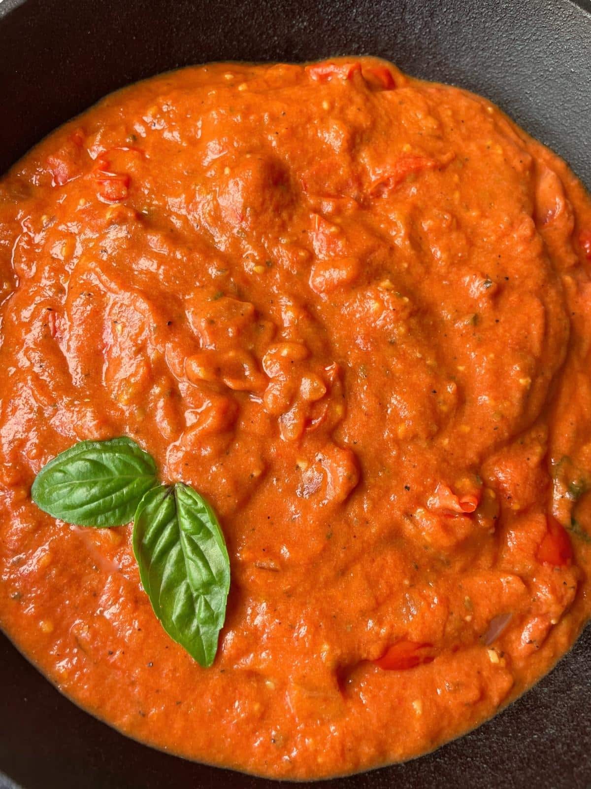 Creamy cherry tomato sauce in a pan.