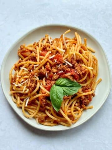Vegan baked spaghetti with basil.
