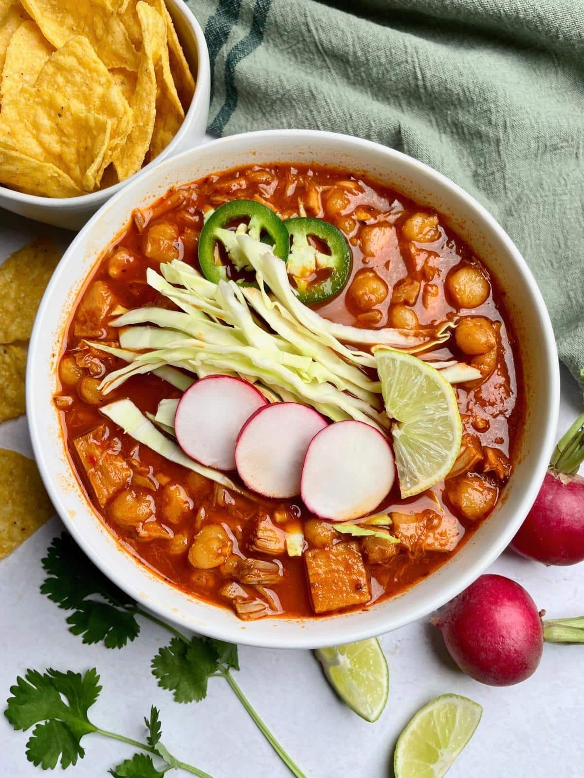 Pozole in a bowl with toppings.