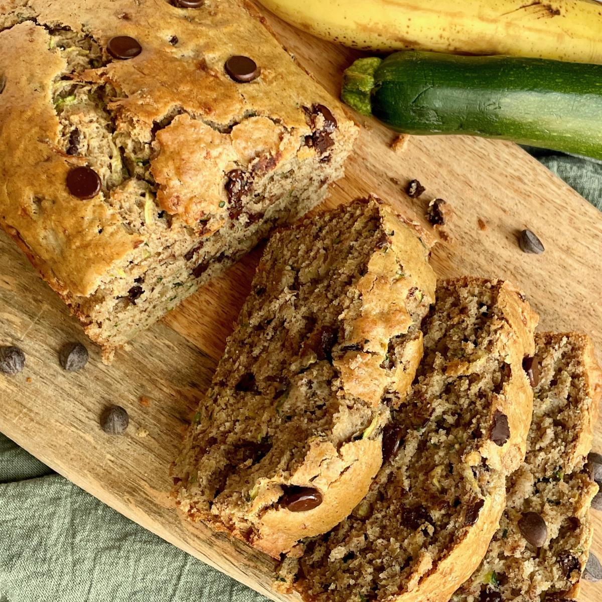 Slices of vegan zucchini banana bread with chocolate chips.