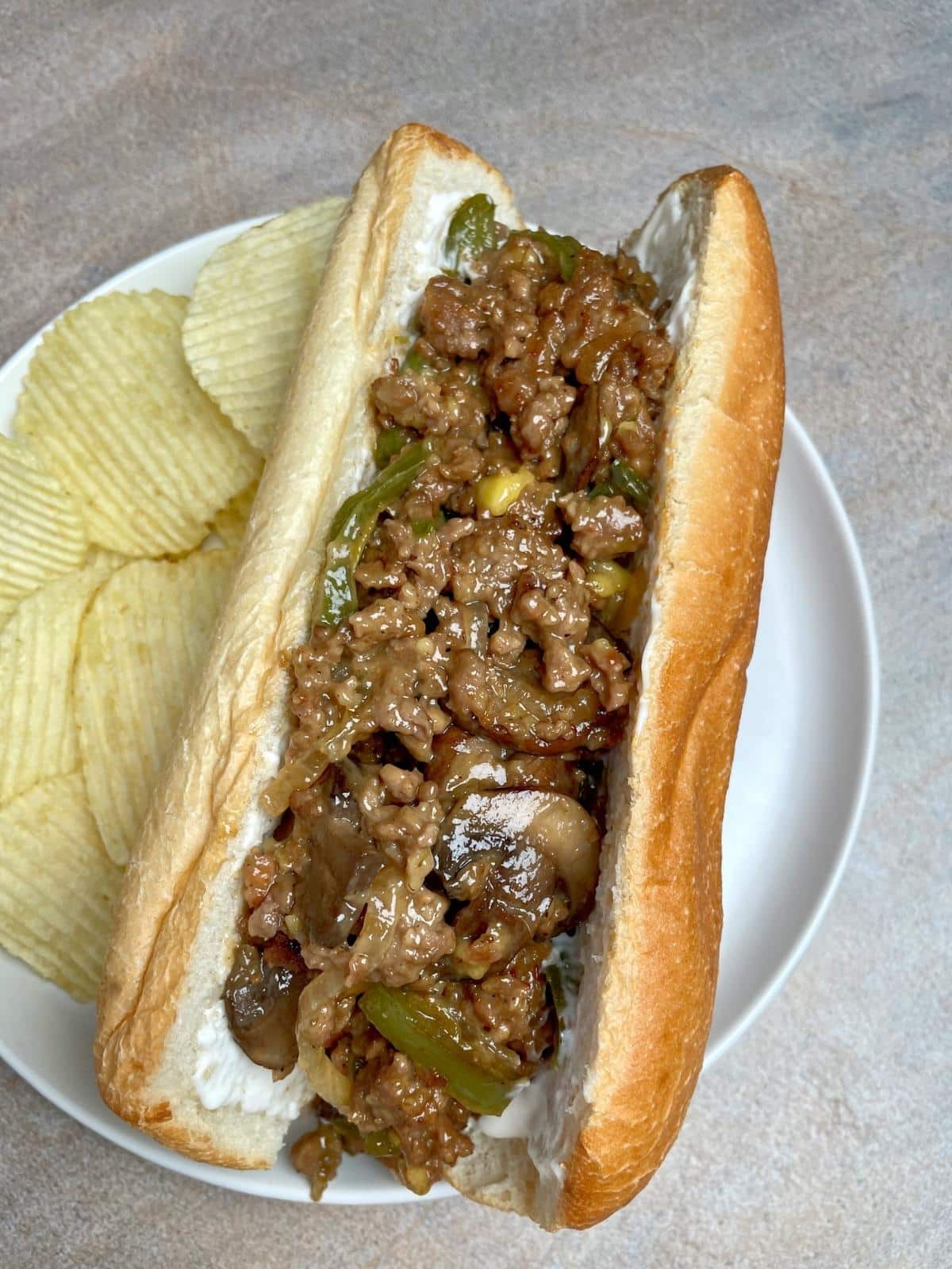 Cheese steak with chips.
