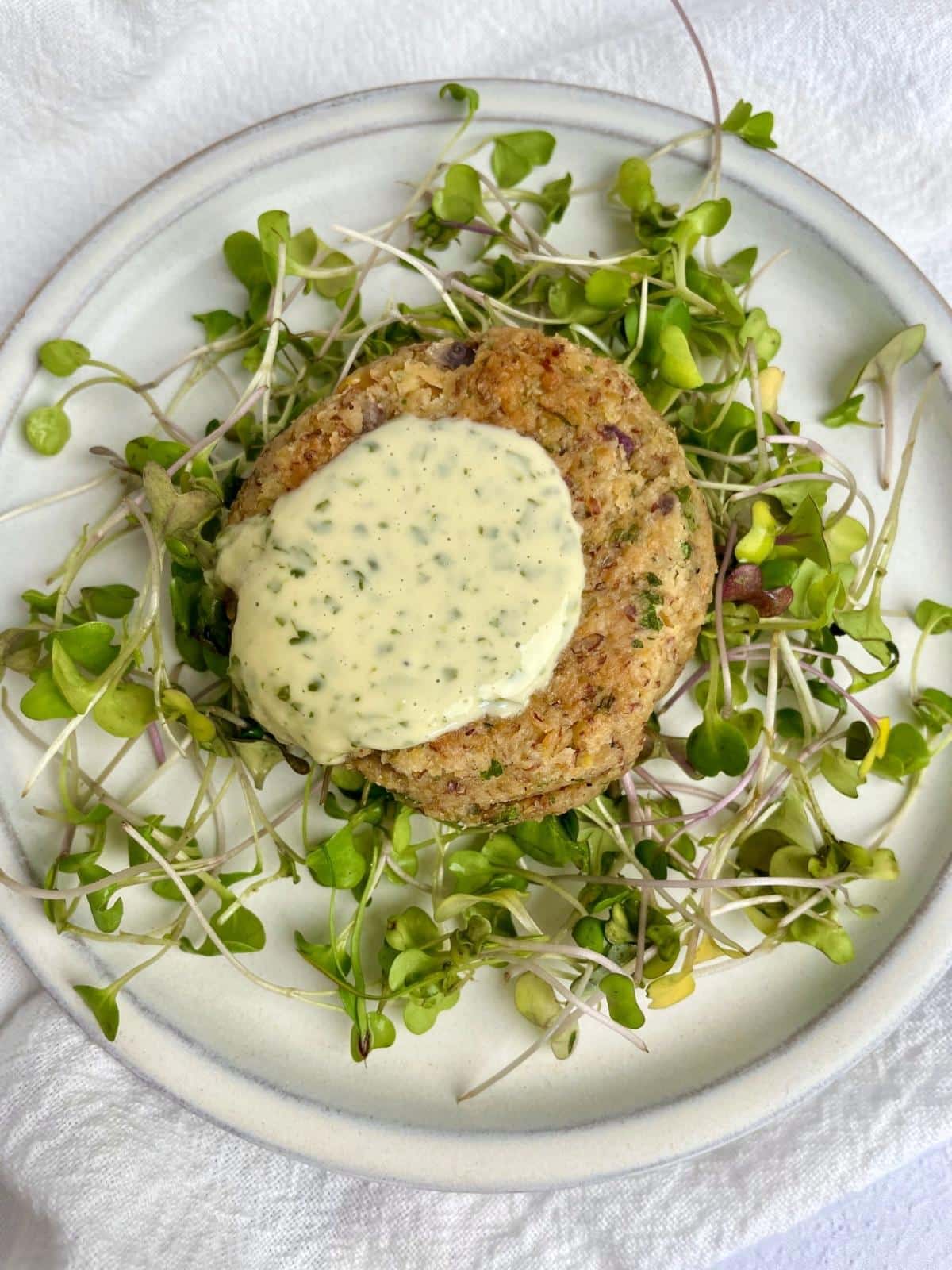 Herb tahini on a chickpea patty.