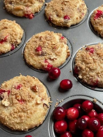 Up close view of cranberry muffins in a tin.