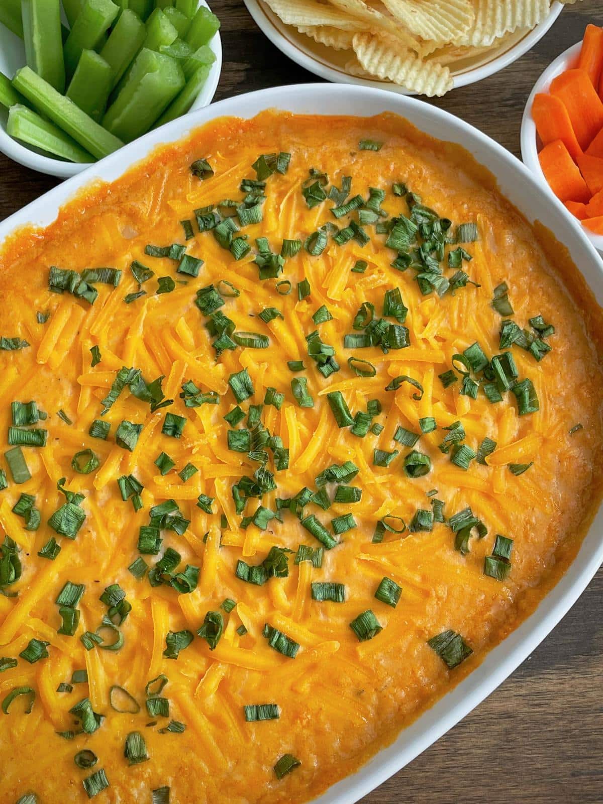 Plant based buffalo dip with green onions.