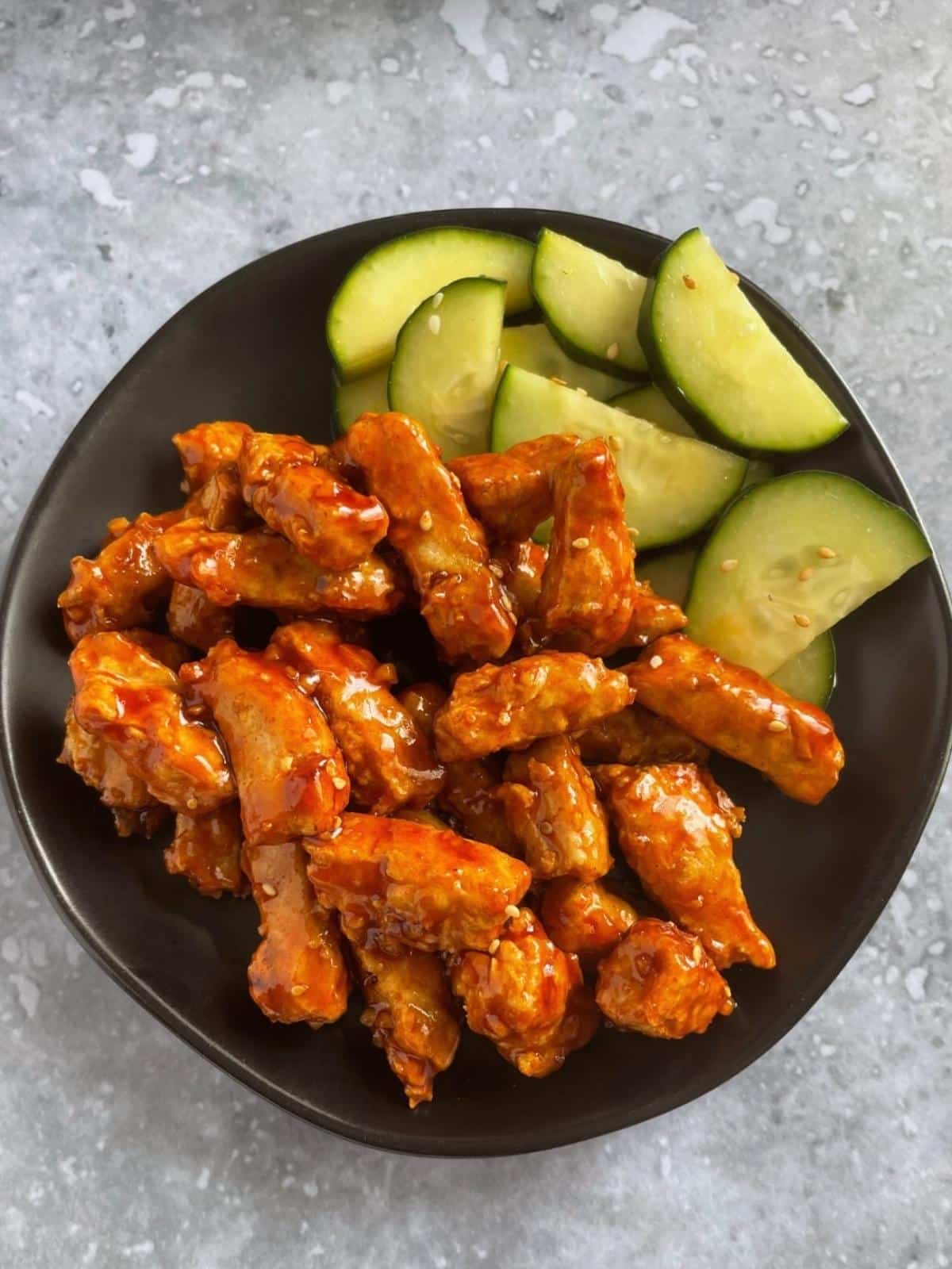Vegan korean fried chicken with a side of cucumber.
