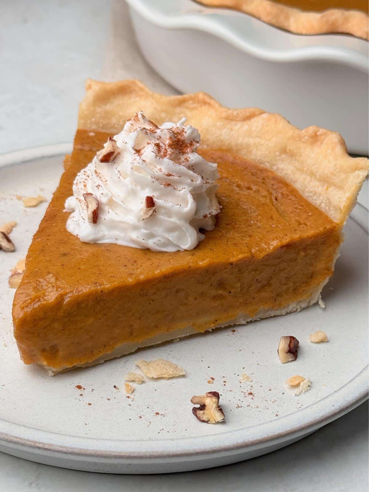A slice of vegan pumpkin pie on a plate.