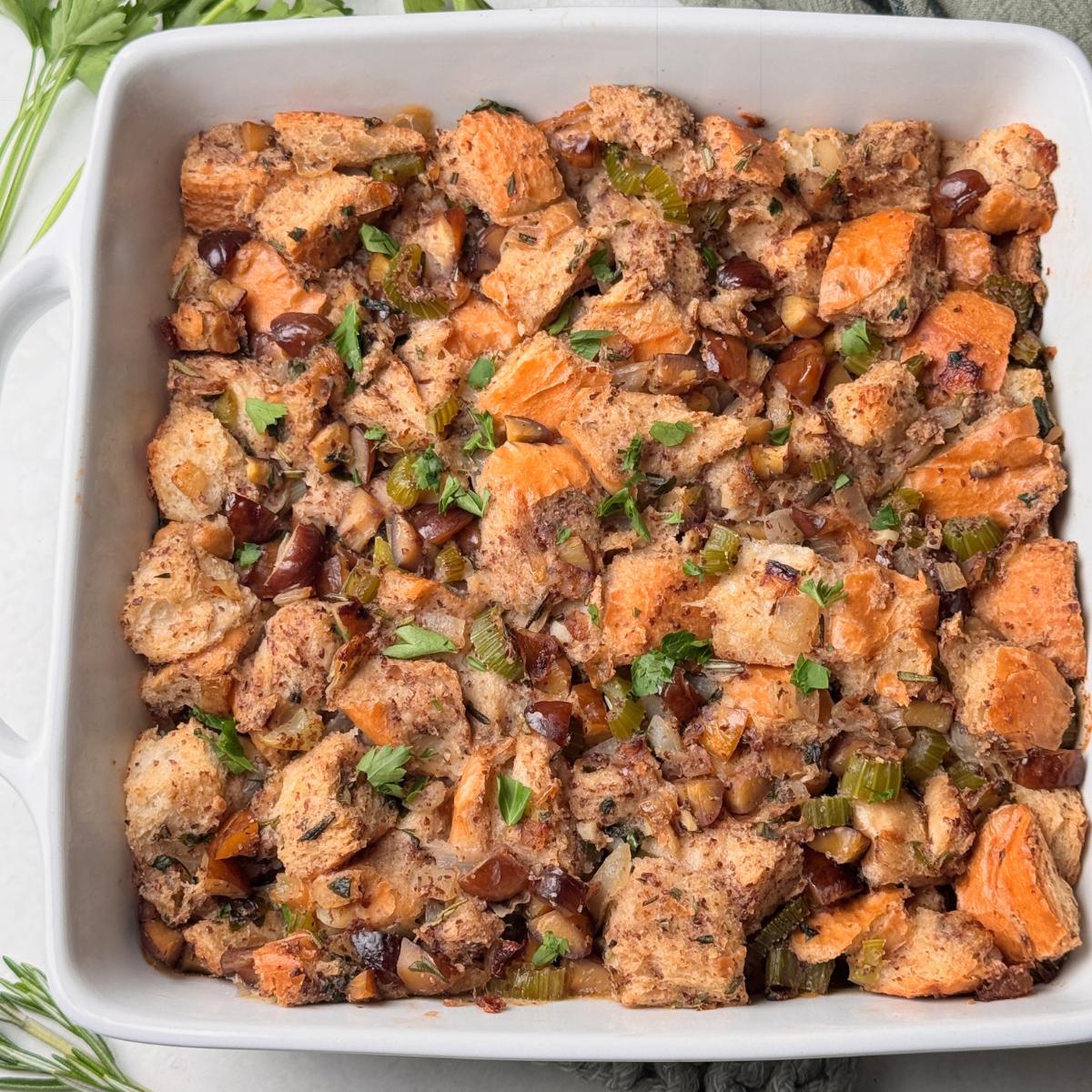 A casserole dish with vegan chestnut stuffing and herbs.