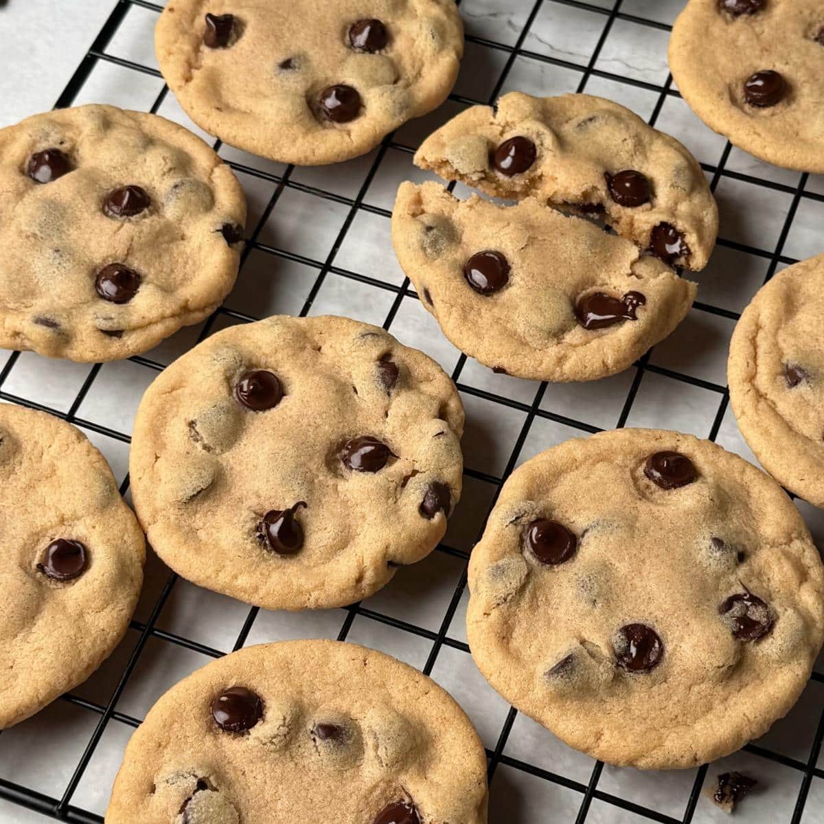 Vegan peanut butter chocolate chip cookies on a cooling rack.
