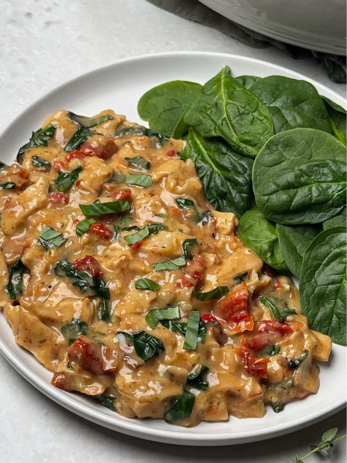 Vegan marry me chicken with a side of greens.