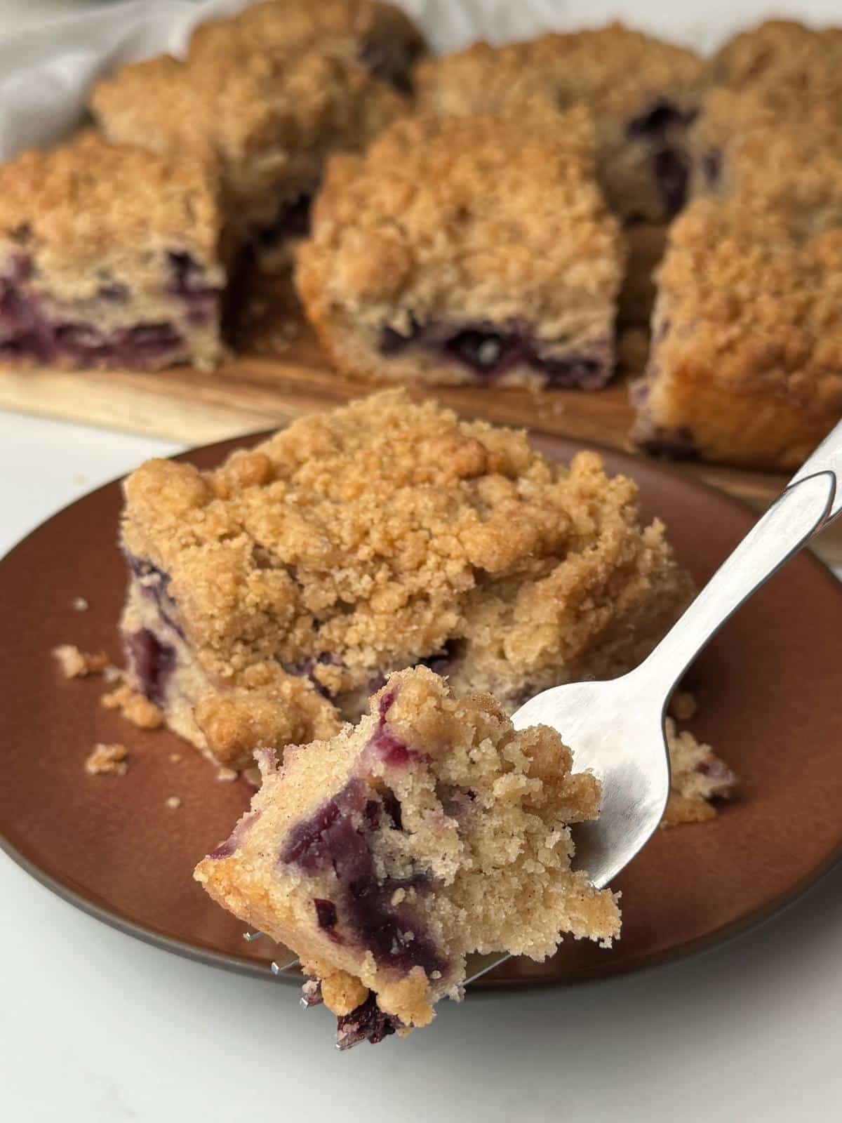 Eating coffee cake with a fork.