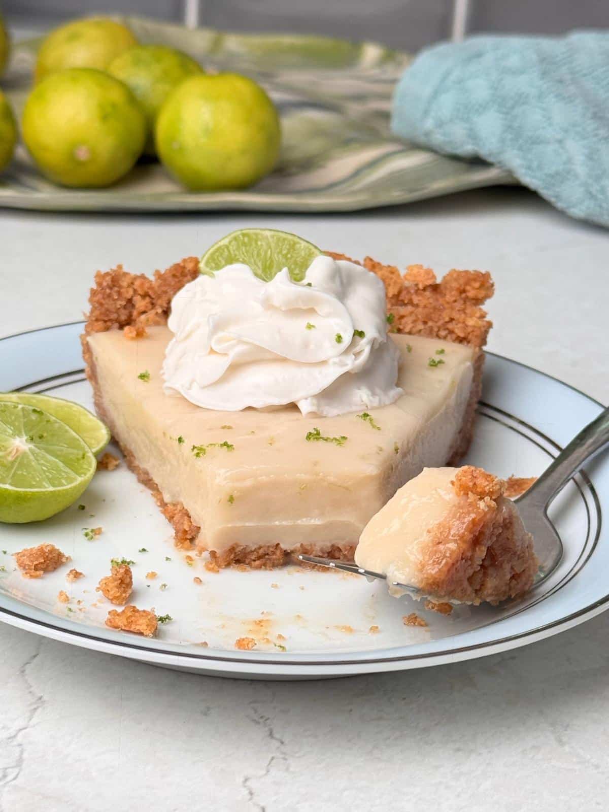 Plant-based key lime pie with whipped cream on top.