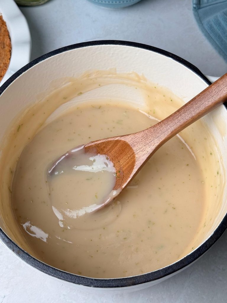 Reducing key lime filling in a pot.