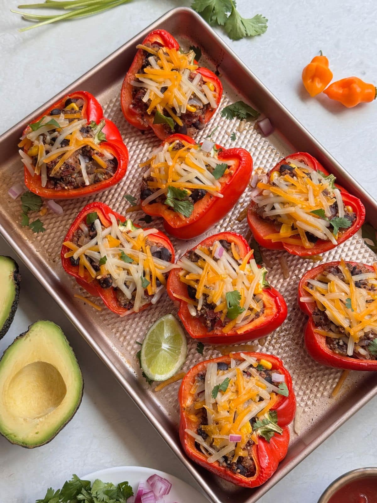 Quinoa stuffed pepeprs with melted vegan cheese on top.