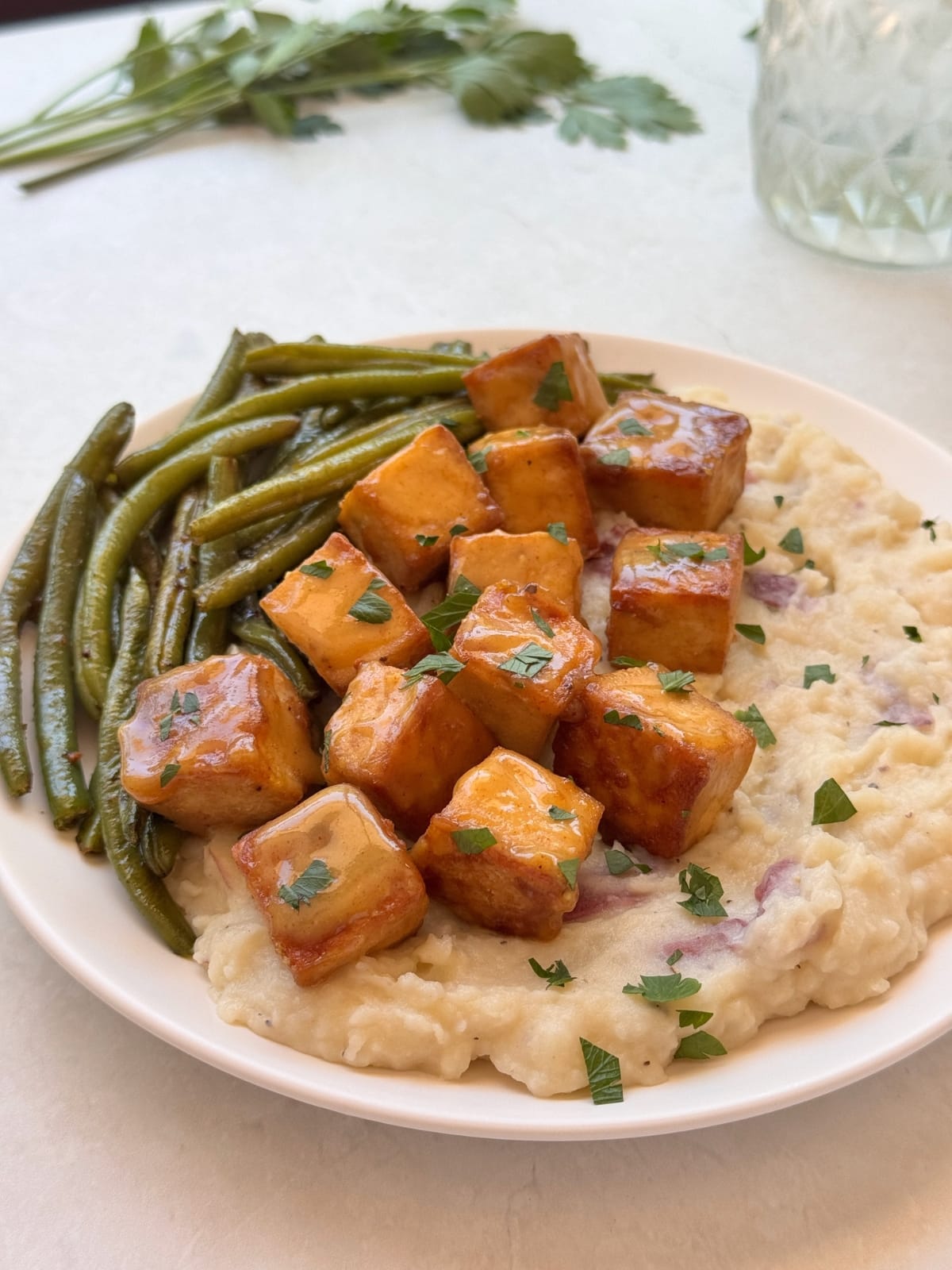 Honey mustard glazed tofu over mashed potatoes.